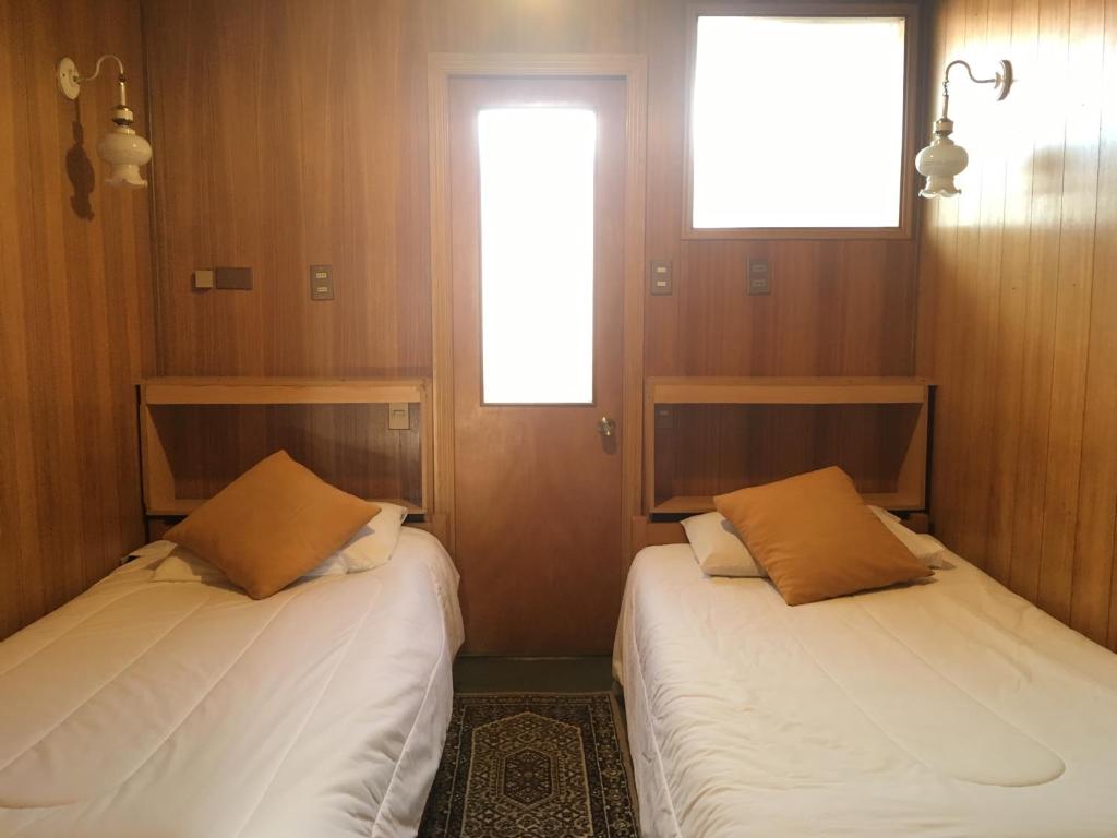 Postel nebo postele na pokoji v ubytování Hostal Buenaventura