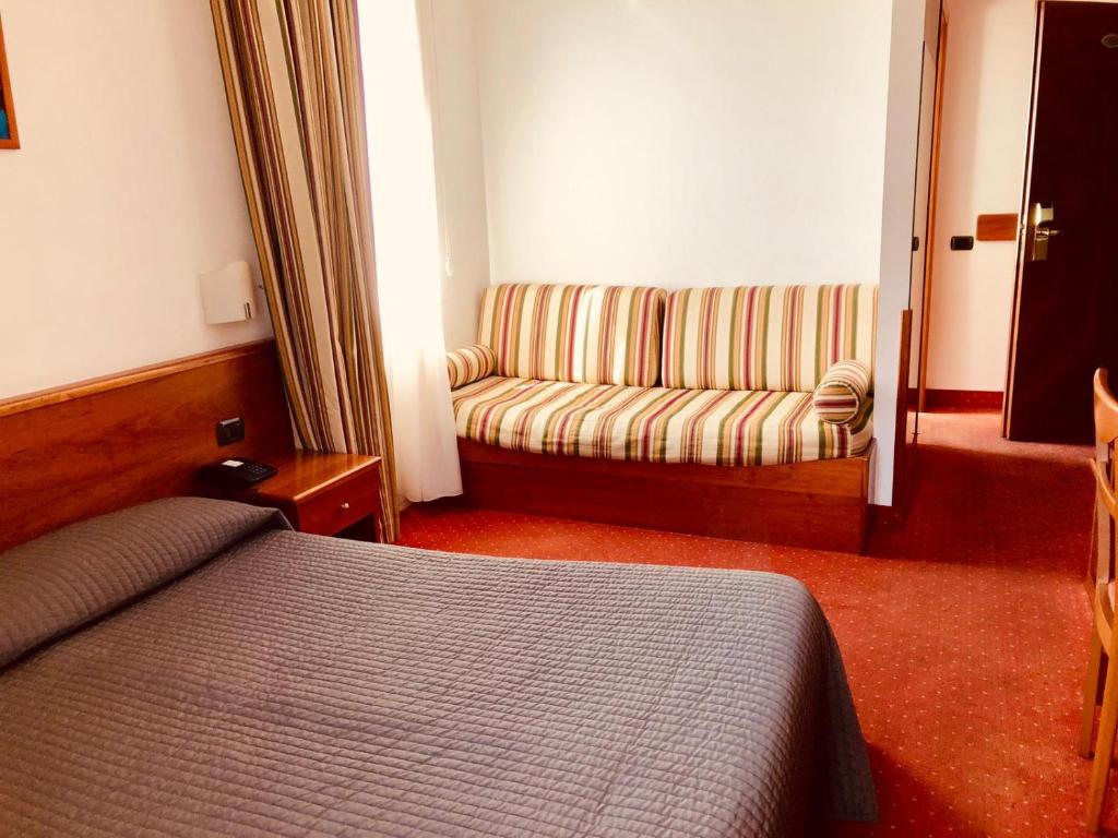 Postel nebo postele na pokoji v ubytování Hotel Serenella