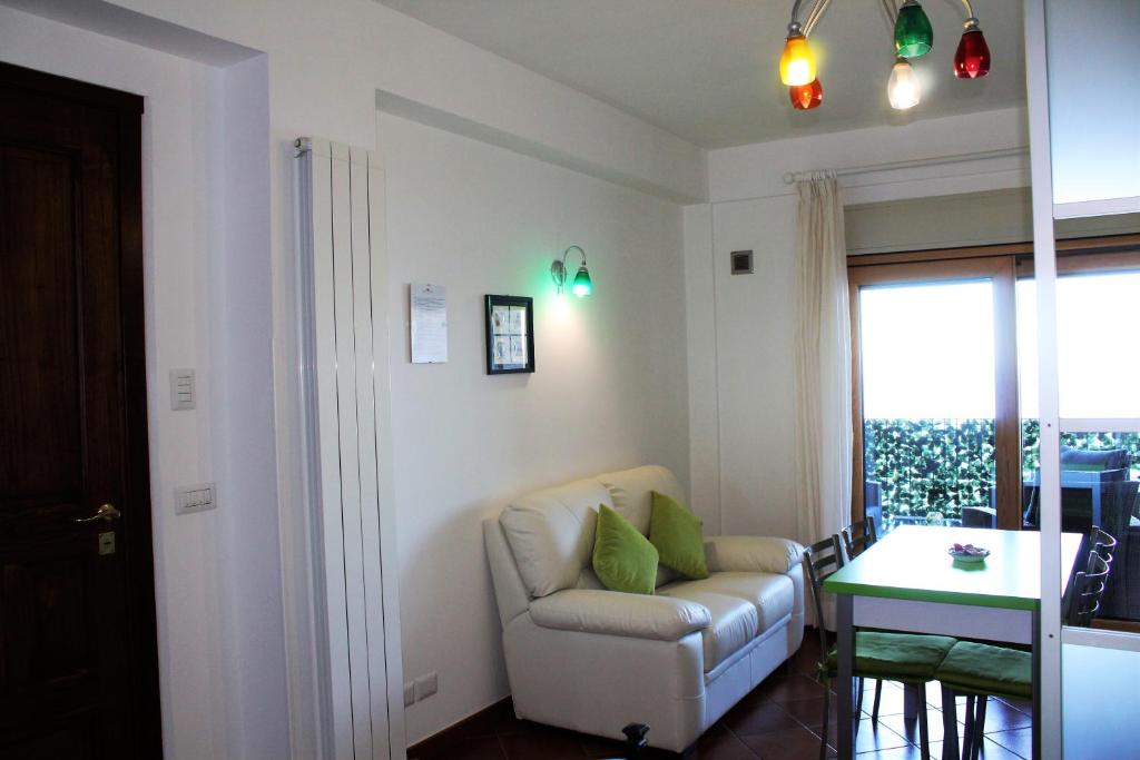 a living room with a chair and a table at Villa Sofia in Taormina