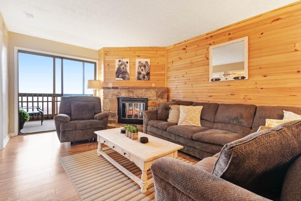 a living room with a couch and a fireplace at Mountain Top Retreat in Gatlinburg