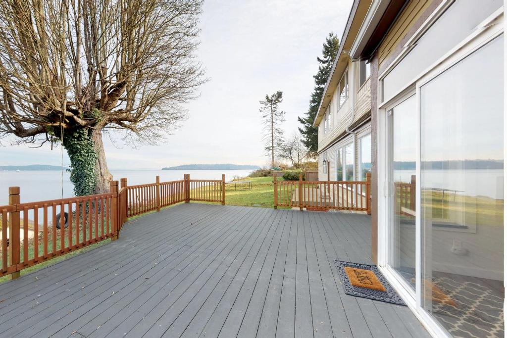 a balcony of a house with a view of the water at Bay Street Oasis in Port Orchard