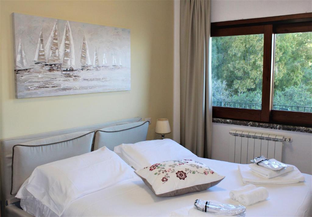 a hotel room with a bed with a window with sailboats at Villa Sofia in Taormina