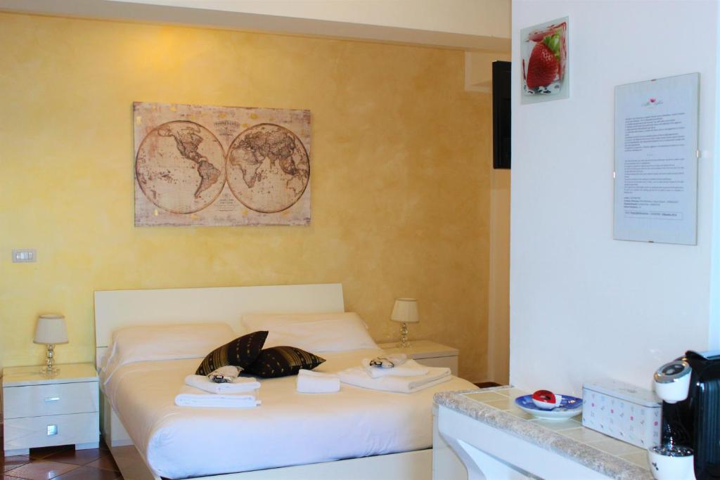 a bedroom with a bed with two towels on it at Villa Sofia in Taormina