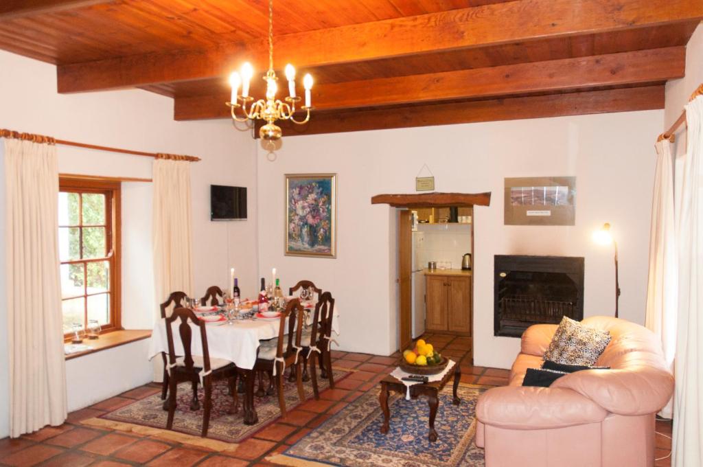 a living room with a table and a dining room at Klein Boschkloof Chalets in Clanwilliam