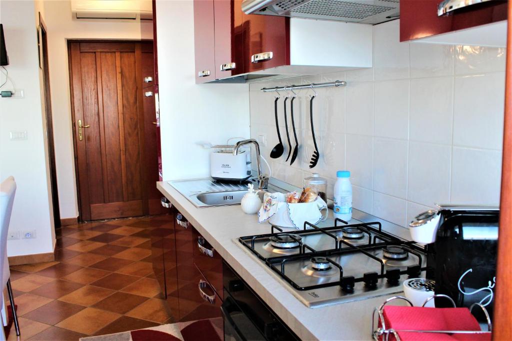 a kitchen with a stove and a counter top at Villa Sofia in Taormina