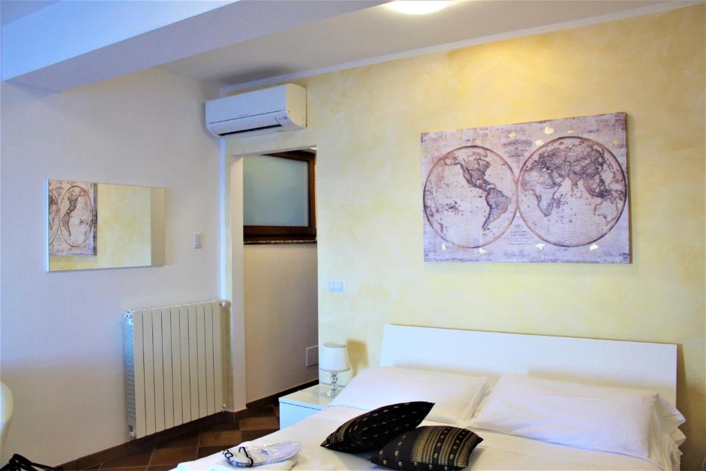 a bedroom with a bed and a painting on the wall at Villa Sofia in Taormina
