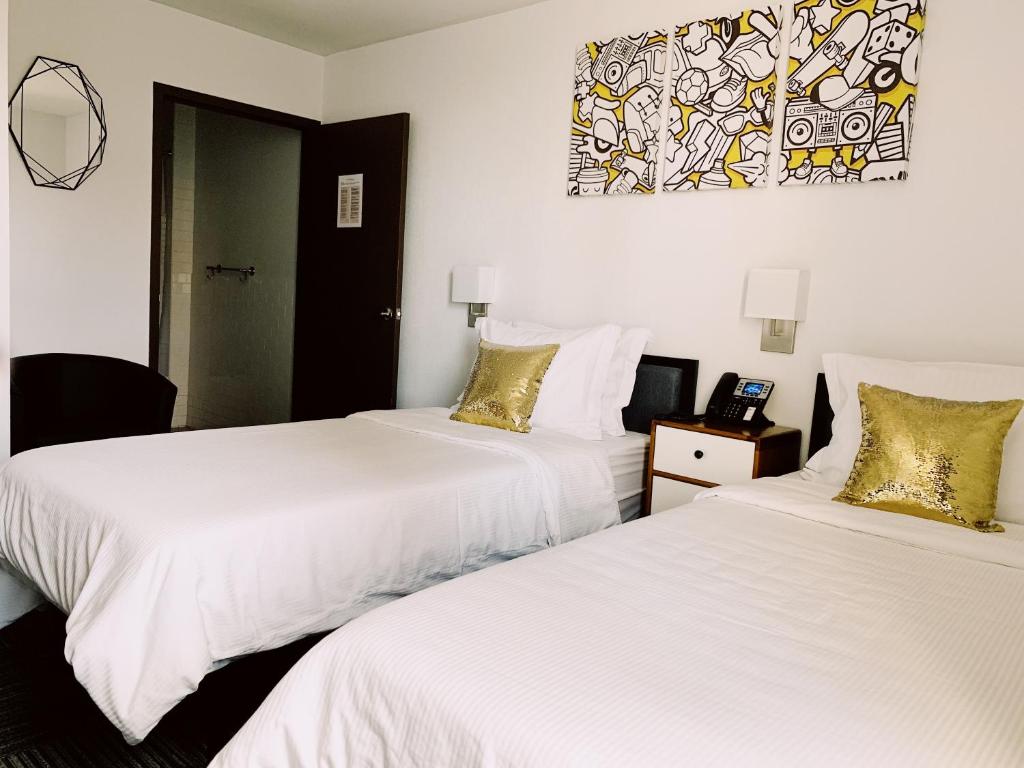 Posteľ alebo postele v izbe v ubytovaní Hotel Mimosa