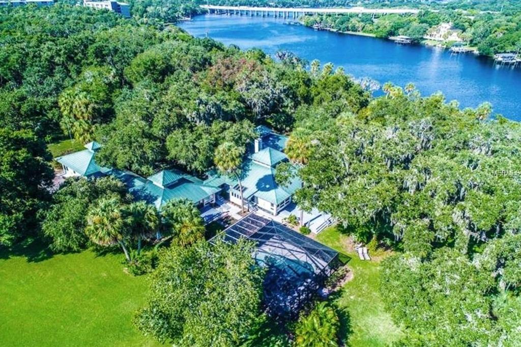 an aerial view of a house on a hill next to a river at Riverbend Retreat Fla in Riverview