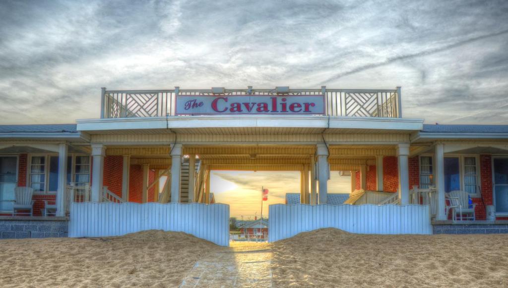 a building on the beach with a sign on it at Cavalier by the Sea in Kill Devil Hills