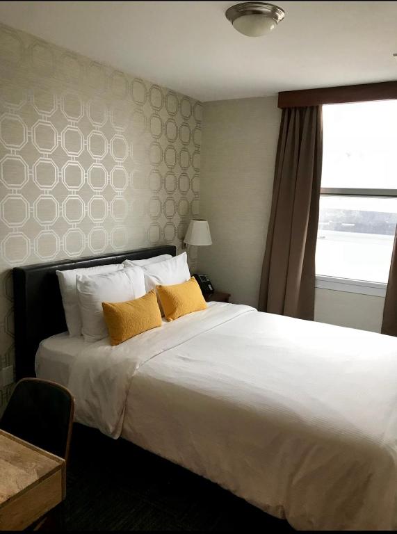 Posteľ alebo postele v izbe v ubytovaní Hotel Mimosa