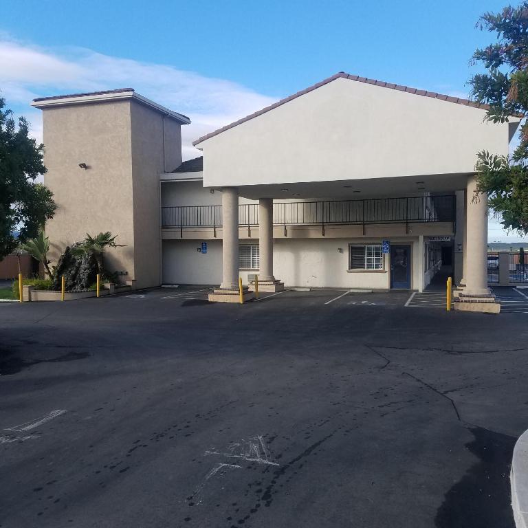 an empty parking lot in front of a building at SureStay Hotel by Best Western Hollister in Hollister