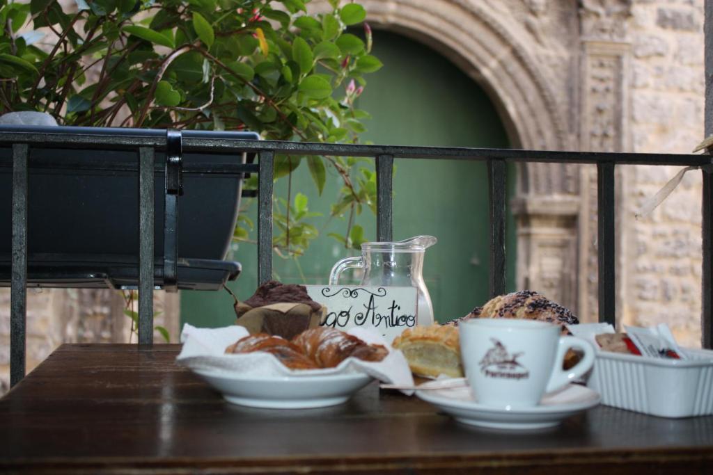 a table with cups of coffee and pastries on it at L'Antica Caiatia in Caiazzo