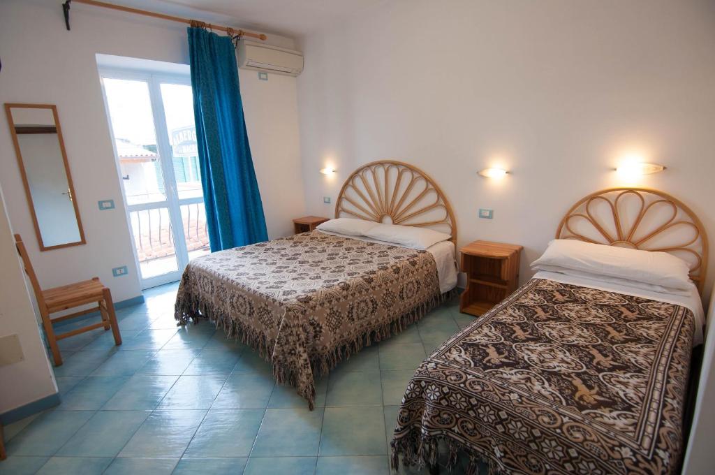 Tempat tidur dalam kamar di Albergo Macrì