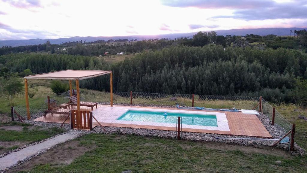 una piscina con cenador al lado en Gran Cabaña en Villa Yacanto en Villa Yacanto