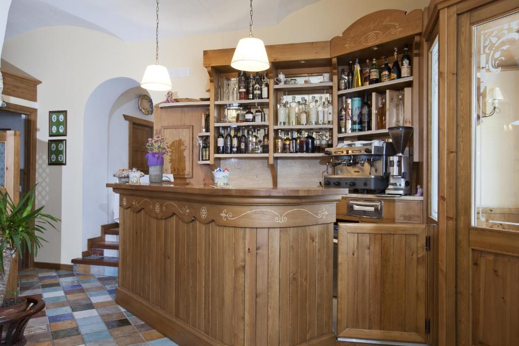 a bar in a restaurant with wooden cabinets at Il Duca Degli Abruzzi in Pescasseroli