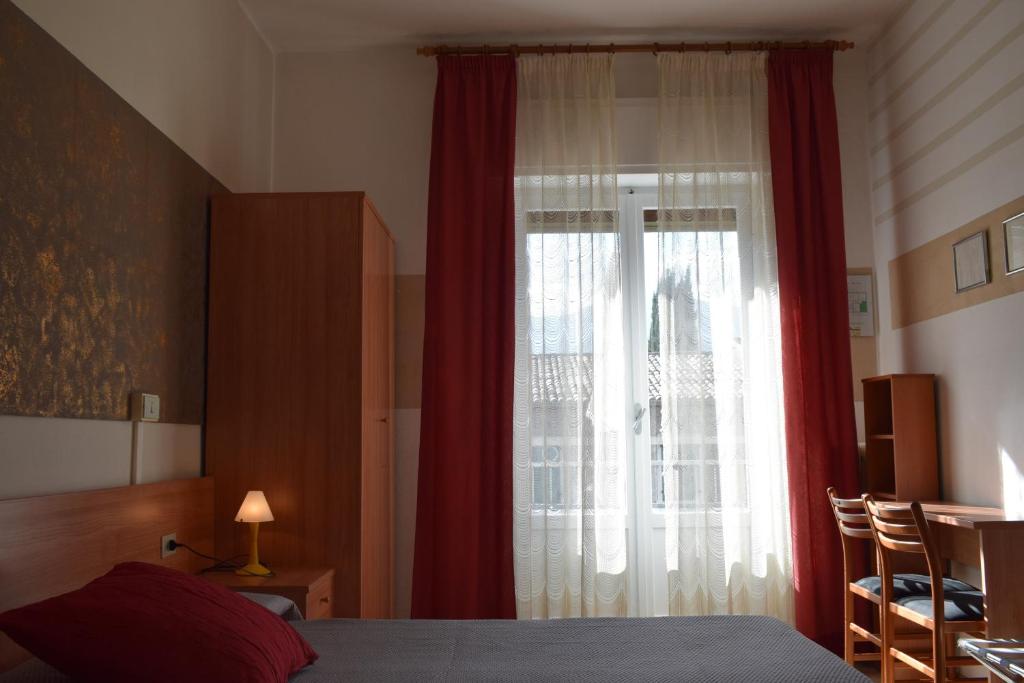 Postel nebo postele na pokoji v ubytování Albergo Al Pescatore