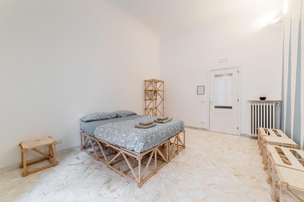a bedroom with a bed in a white room at Macchia Mediterranea Guest House in Bari