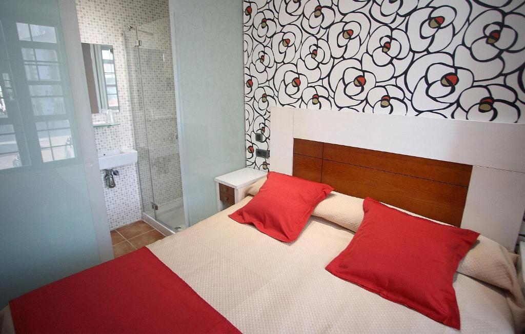 A bed or beds in a room at Hostal Centro