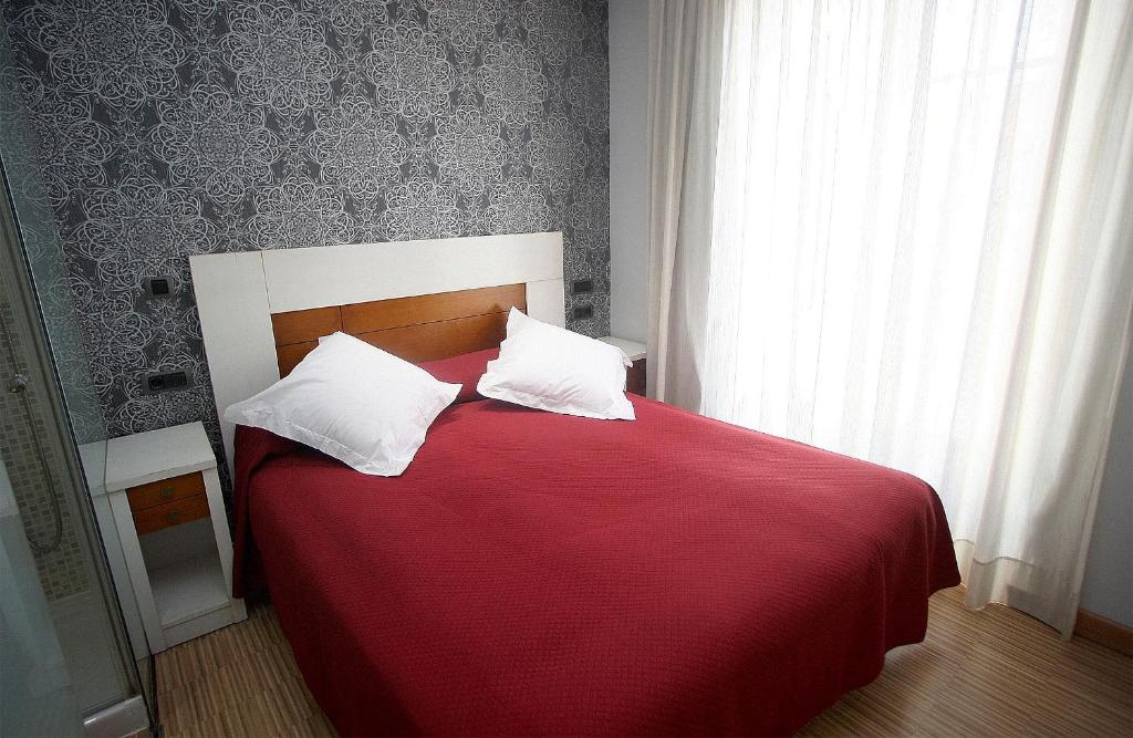 A bed or beds in a room at Hostal Centro