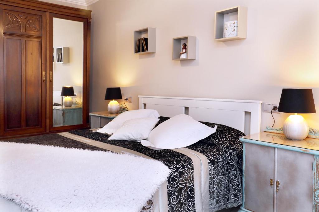 a bedroom with a bed with white pillows on it at Cal Sisquet - LOLA in La Seu d'Urgell