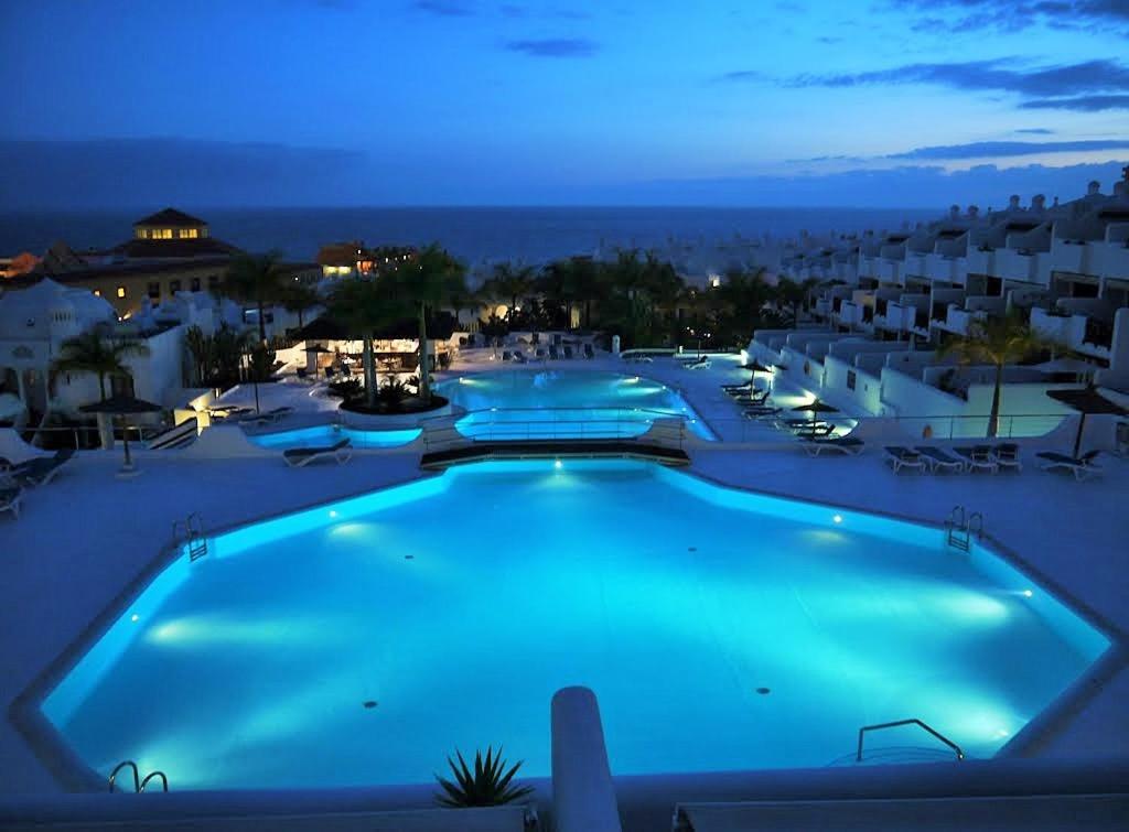 una gran piscina en un complejo por la noche en Apartment luxury complex with sea view, en Adeje