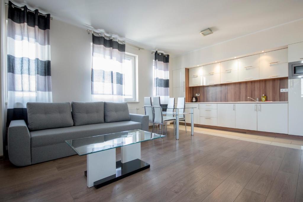 a living room with a couch and a table at NotaBene Wola Apartment in Warsaw