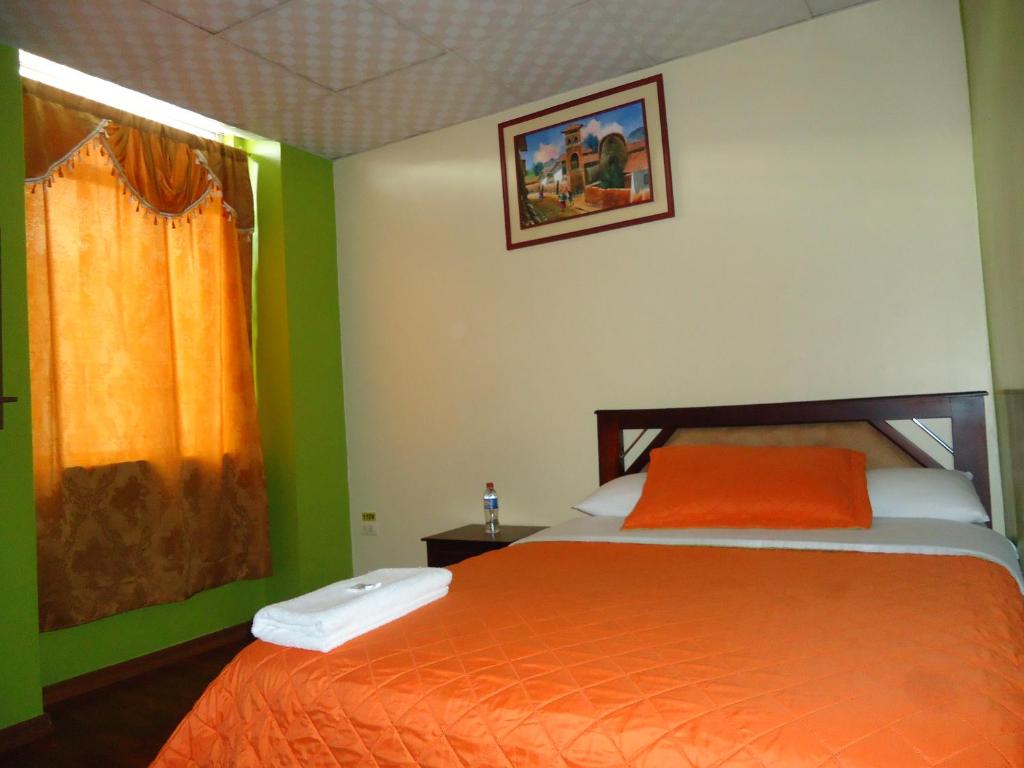 Postel nebo postele na pokoji v ubytování Hostal Bolívar Inn