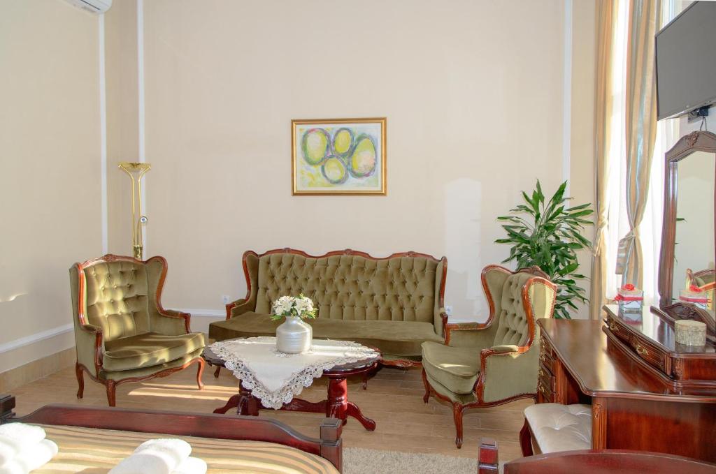 a living room with a couch and chairs and a table at Apartments Skadarlija in Belgrade