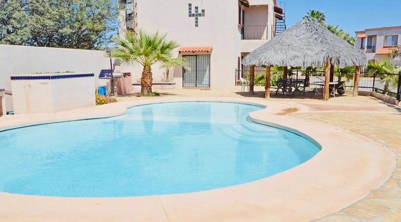a large blue swimming pool in front of a building at Villa in Tranquil Gated Community, 2 Bedroom 2 Bath in Puerto Peñasco
