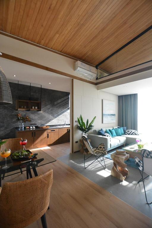 a living room with a couch and a table at The Cabin Beach Resort in Haad Rin