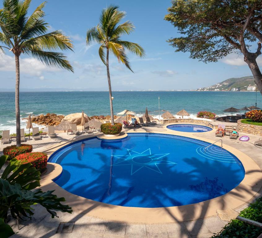 a swimming pool with the ocean in the background at Ocean Front, 3 bedroom, 3 bathroom, Casa Natalia, Playa Esmeralda in Puerto Vallarta