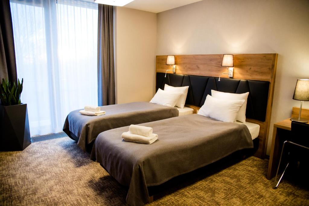 Postel nebo postele na pokoji v ubytování APART HOTEL 12