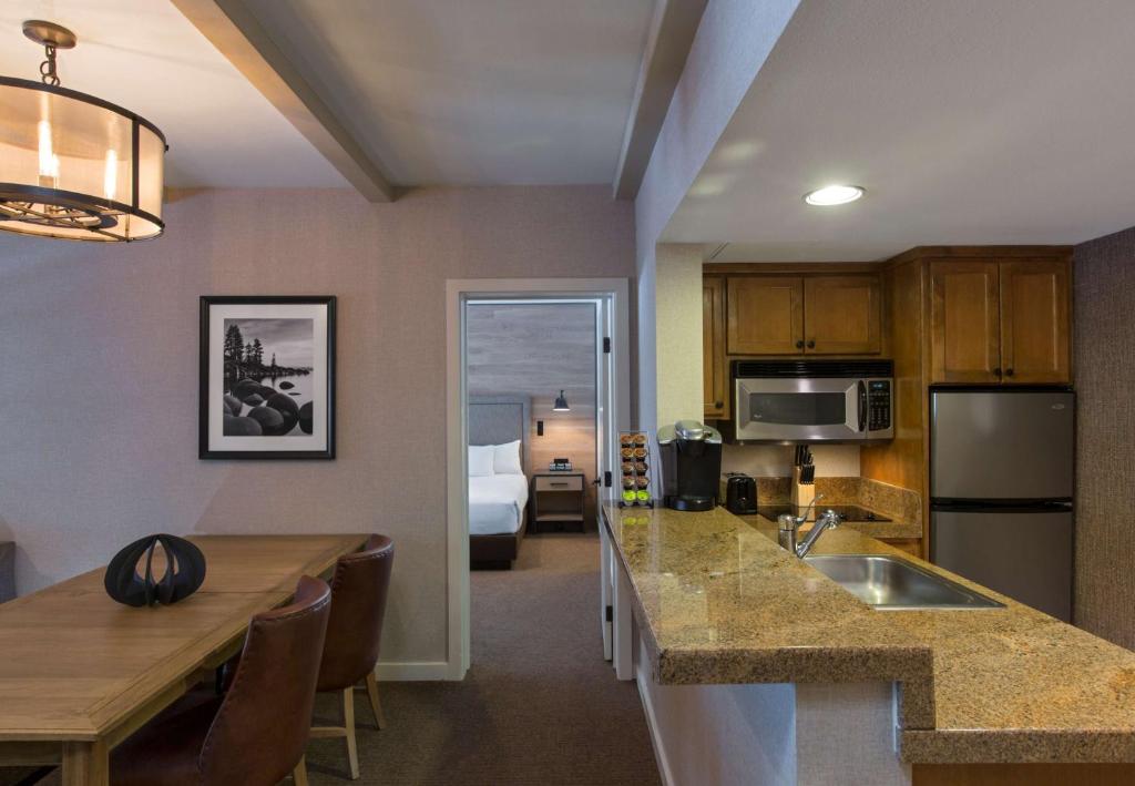 a kitchen with a refrigerator, sink, and counter top at Hyatt Regency Lake Tahoe Resort, Spa & Casino in Incline Village