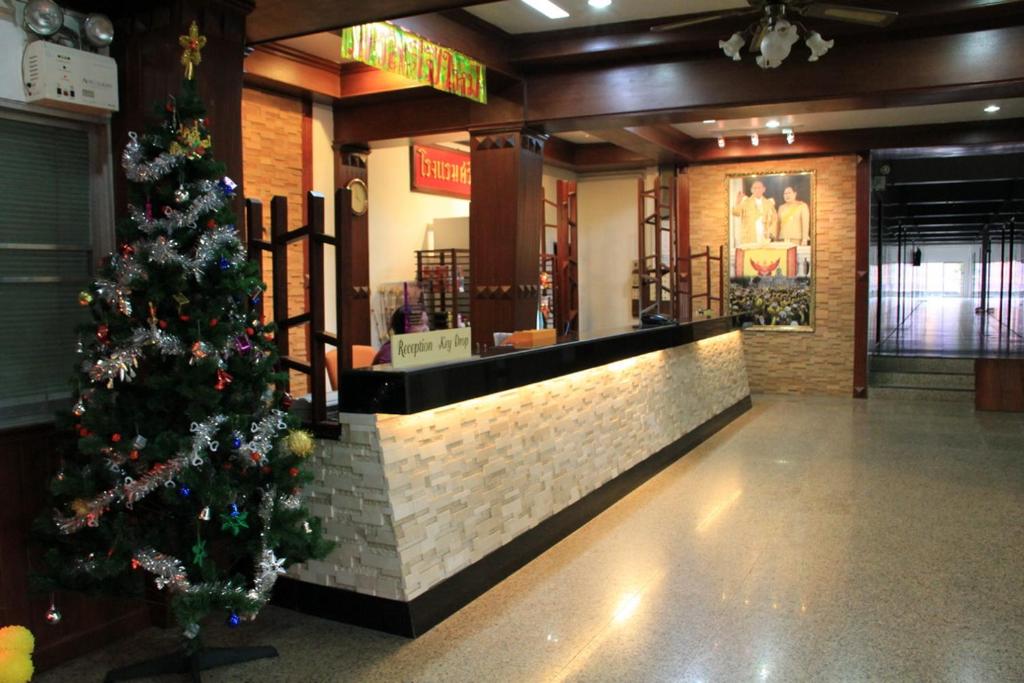 a christmas tree in the lobby of a restaurant at Sri Chumphon Hotel in Chumphon