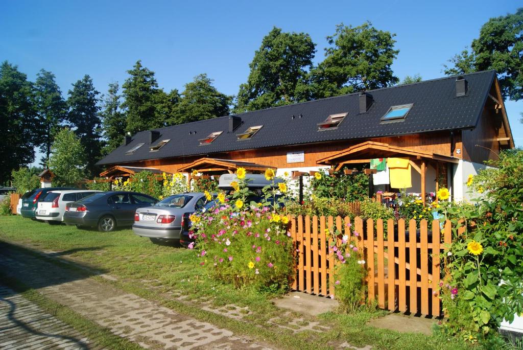 a house with cars parked in front of it at Białka in Białogóra