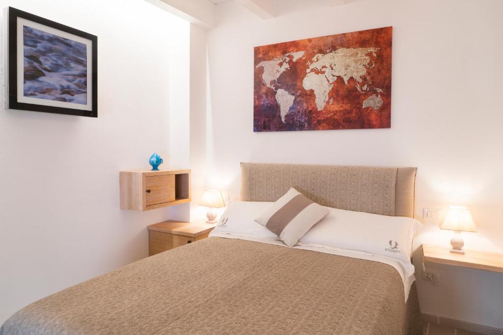 Postel nebo postele na pokoji v ubytování Quintessenza Luxury Domus