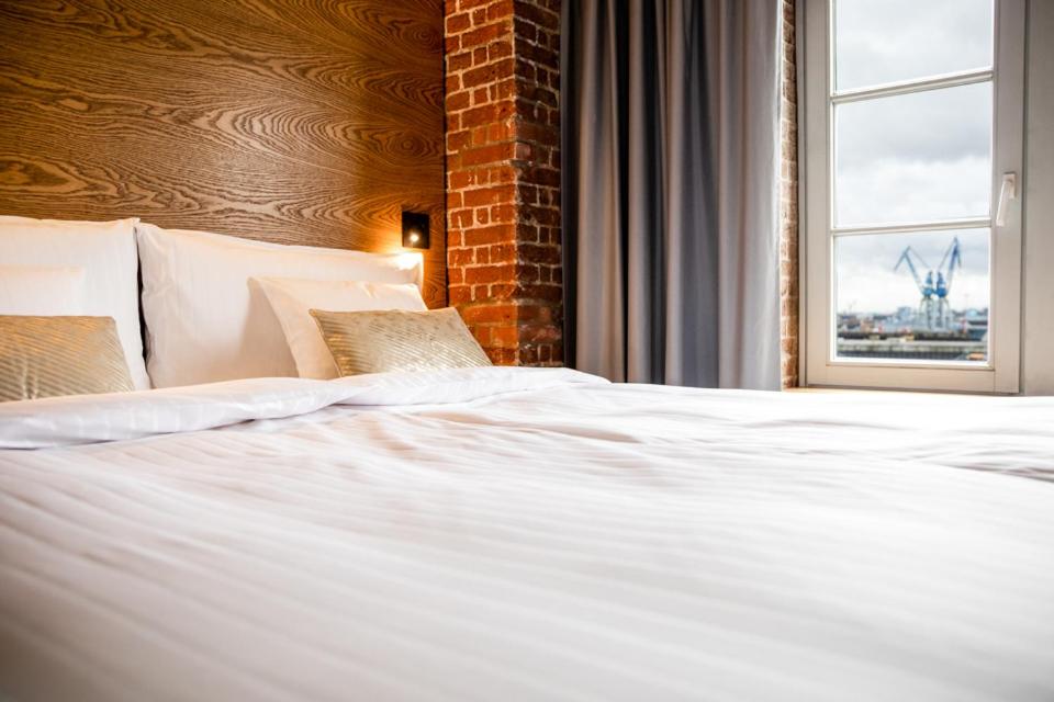 Postel nebo postele na pokoji v ubytování GINN Hotel Hamburg Elbspeicher