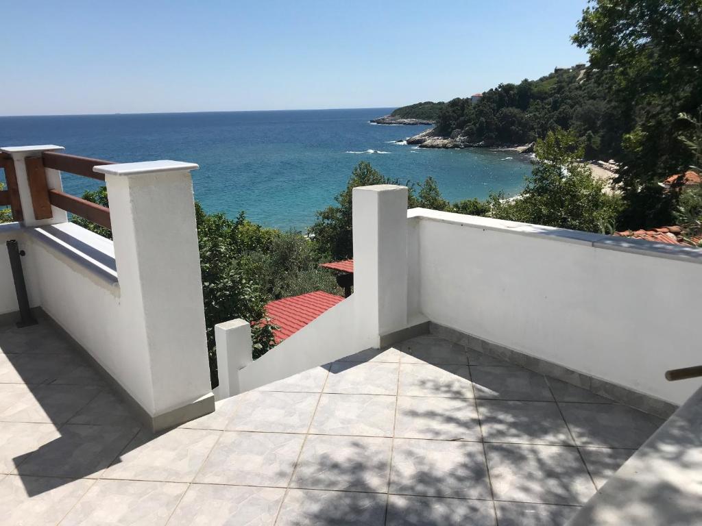 a white balcony with a view of the ocean at Appartments Zoe in Agios Ioannis Pelio