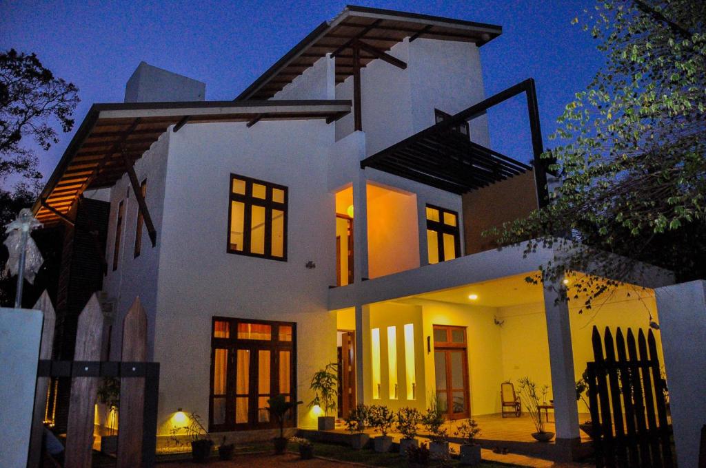 a large white house at night at Amuththa Resort in Anuradhapura