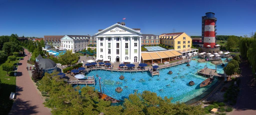 an aerial view of a resort with a large swimming pool at 4-Sterne Superior Erlebnishotel Bell Rock, Europa-Park Freizeitpark & Erlebnis-Resort in Rust