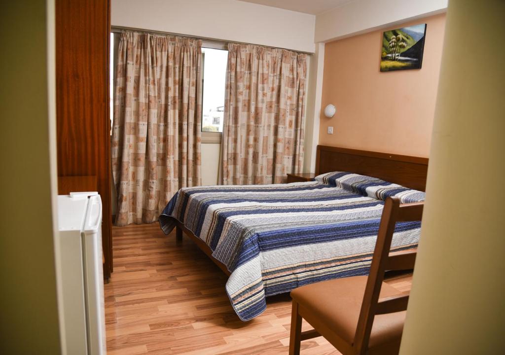 Postel nebo postele na pokoji v ubytování Elysso Hotel