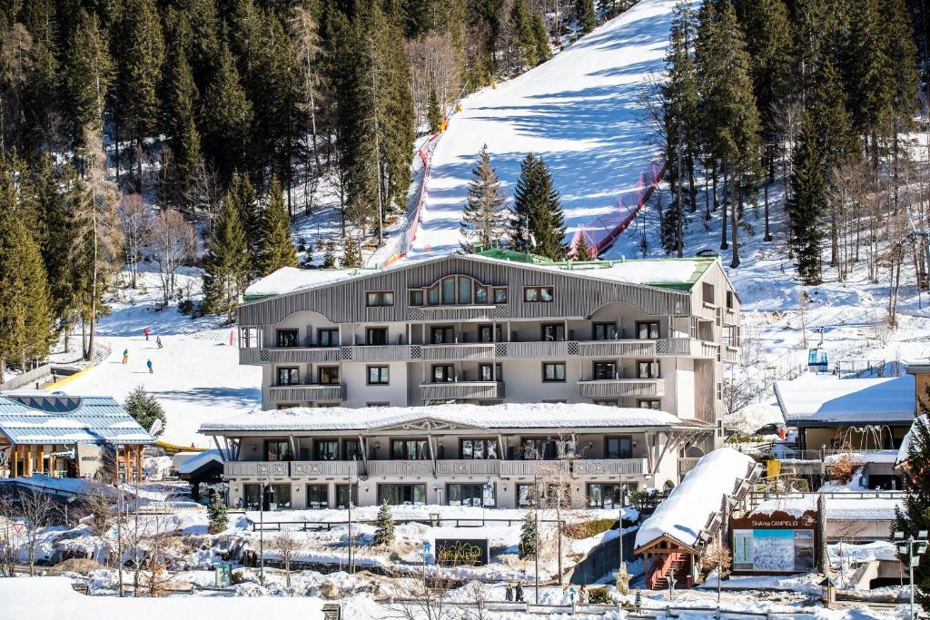 
a large building with a ski lift on top of it at Hotel Spinale in Madonna di Campiglio
