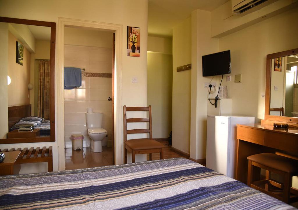 Postel nebo postele na pokoji v ubytování Elysso Hotel