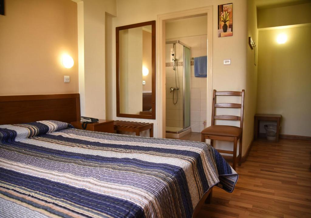 Postel nebo postele na pokoji v ubytování Elysso Hotel