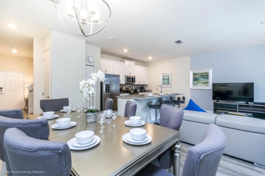 a dining room and living room with a table and chairs at Imagine You and Your Family Renting this 5 Star Home on Champions Gate Resort, Orlando Townhome 2539 in Davenport
