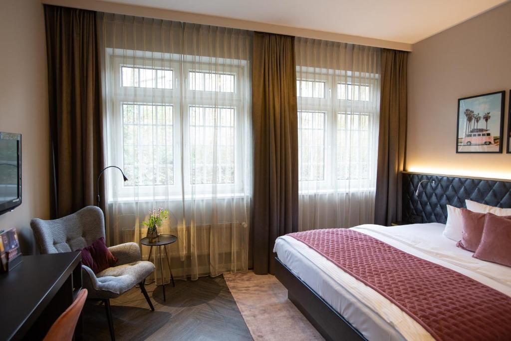 Postel nebo postele na pokoji v ubytování Boutique Hotel Poppenbütteler Hof