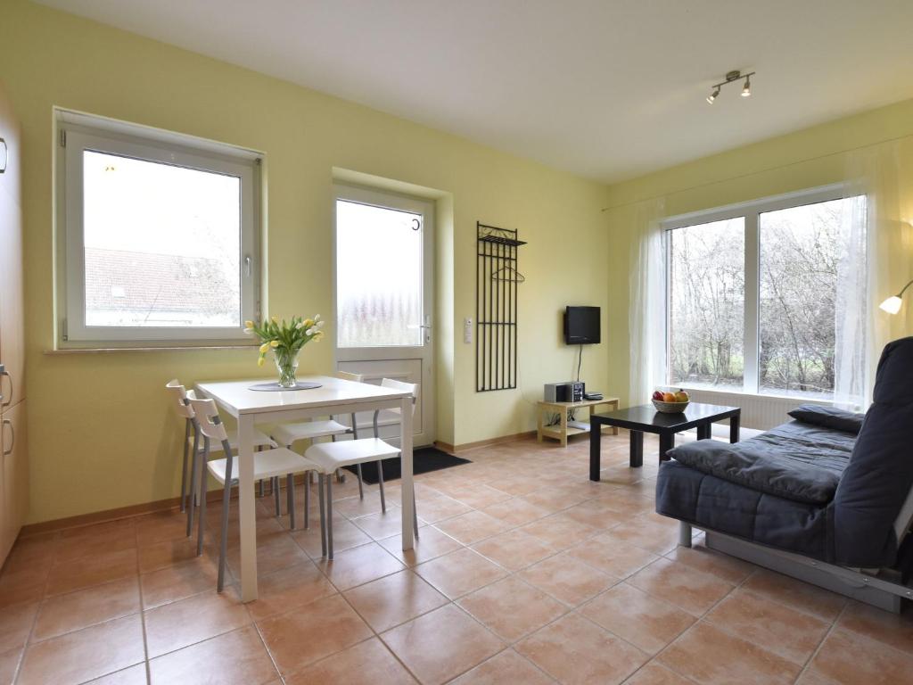 a living room with a table and a couch at Peaceful Apartment in Zierow with Terrace in Zierow