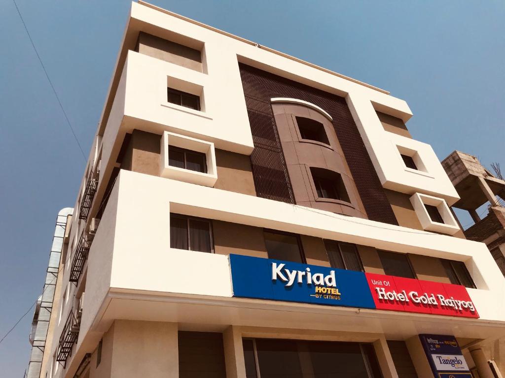 a tall building with a kryptid sign on it at Kyriad Hotel Solapur by OTHPL in Solapur