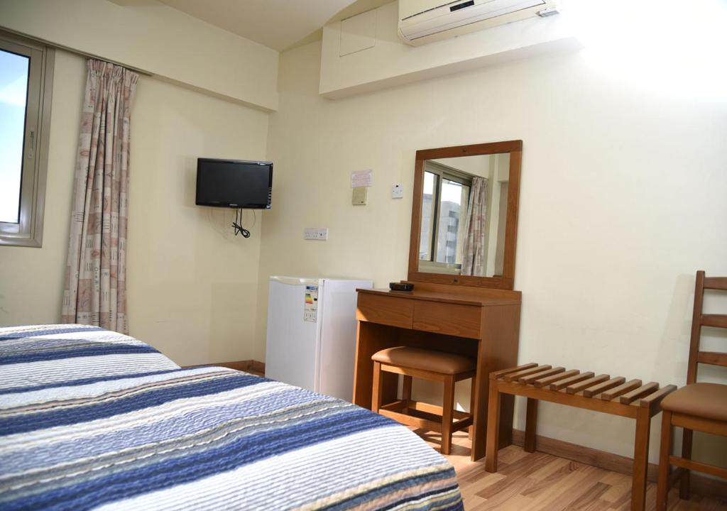Postel nebo postele na pokoji v ubytování Elysso Hotel