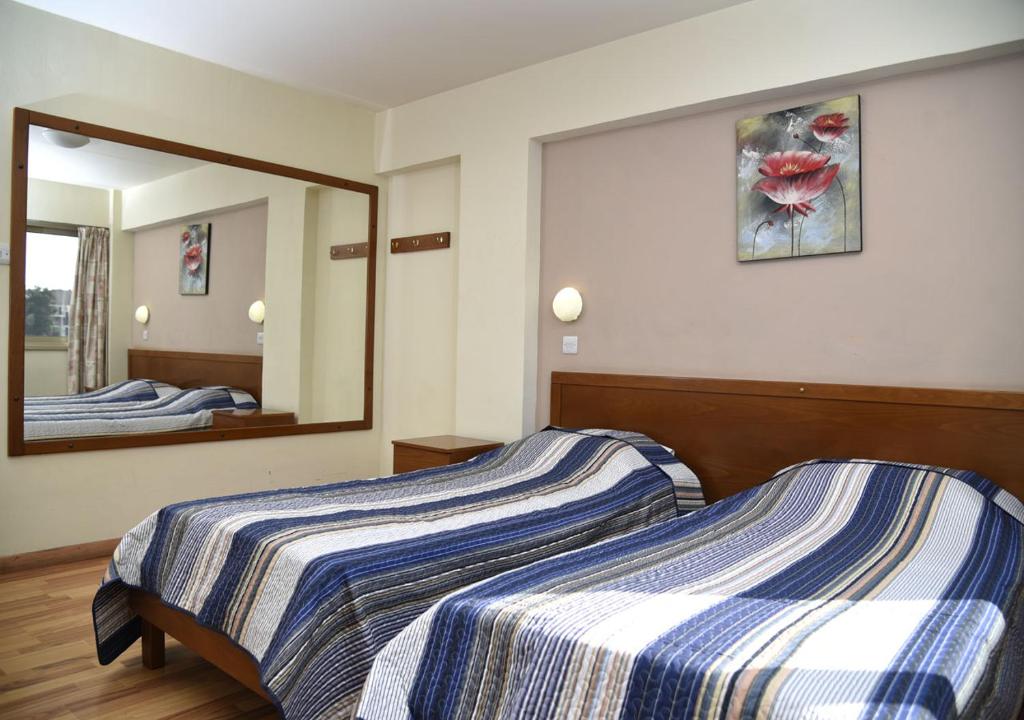 Postel nebo postele na pokoji v ubytování Elysso Hotel